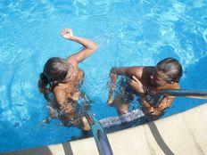 Young ladies sunbathe rest and swim