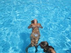 Young ladies sunbathe rest and swim