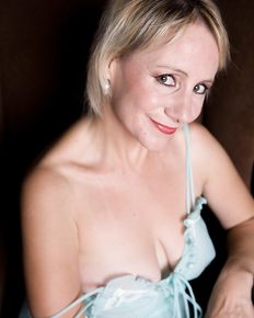 Tiffany is posing in blue negligee