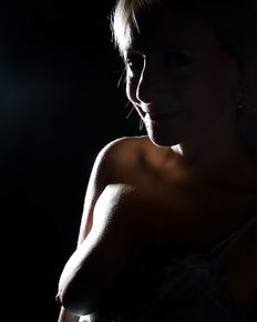 Tiffany is posing in blue negligee