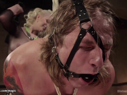 Man in invered suspension ass caned