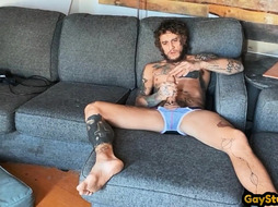 Solo tattooed horny stud masturbates using sex toys