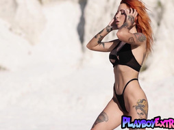 Naked red babe showing her sexy tattoos